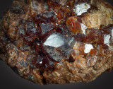 Valle della Gava trisoctahedral grossular (hessonite), main crystal about 12 mm across