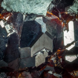 Valle della Gava grossular (hessonite) showing tetrahexahedron and cube, main crystal about 10 mm across