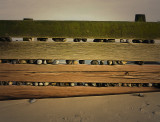 Photo of Stones caughtup in breakwater, Walcott, Norfolk,UK