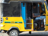 Looks somewhat young to be driving his own authrickshaw