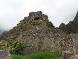People climbing to the Intihuatana at Machu Picchu