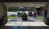 Compacting the new asphalt in an area being repaired