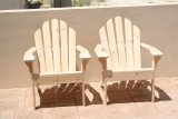 A pair of adirondack chairs