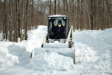 Bobcat clearing the road