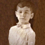 A photo of a very old photo of my father as a young boy