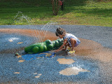 Little girl playing in Splash Pad at Fishermans Park