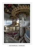Upright shaft with spurwheel and the milling stones