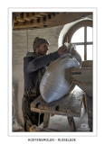 Filling the feeder with wheat