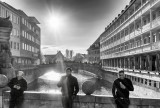 Three men on a bridge