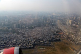Departing past the shanty town on the south side of Mumbai Airport, India