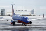 Snowy Southwest B737 in front of the United hanger at DEN