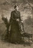 Lady posing by an Interesting Chair 