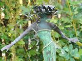 Curly-haired mermaid sculpture.