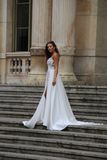 An attractive and lovely woman on the steps of the Palais de la Bourse