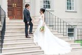 Bride and Groom on grand stairs in front of the Estate where they were married.
