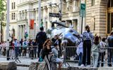 People line up to have their pictures taken at the rear, rather than the front, of the Charging Bull near Wall Street in NYC