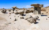 Two tall hard rock hoodoos surrounded by smaller hoodoos in the Bisti Wilderness