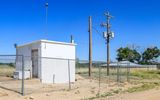Well House with Water Reservoir in the background in Amache NHS