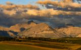 Sunrise bathes the Rocky Mountains and the clouds above in Waterton Lakes NP 