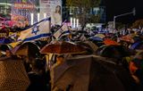 Demonstrators protest on a rainy evening against the constitutional cue in Israel