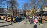 Cheerful crowds enjoying early Spring sunshine