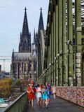 Koln; the cathedral, the bridge and carnival costumed people. 