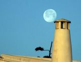 Moon and traditional chimney stack on estate