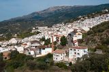 White Village of Competa spills down a hillside in the Sierra Almijara