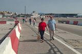 Crossing the airport runway to leave and enter the territory