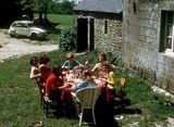 Hospitable French students lunching at their rented farmhouse in Brittany