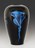 Hollow turned vessel with iridescent paint.