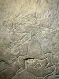 Detail of Ragnarok Stone showing individual in pointed helmet with foot held in the jaws of the large canine.