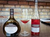 Wine tasting at Davino.  Shows the traditional flat wine bottle of the Franken wines.