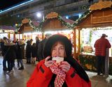 Susan eating a Schaumkuss (Foam Kiss) at Kaiser Wilhelm Memorial Church Christmas Market
