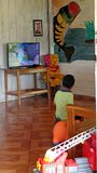 Boy watching cartoons in small Amazon village