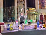 Bonnie the bartender juggling 3 liquor bottles