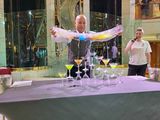 Bonnie (head bartender at Crooners Bar) filling 9 Martini glasses at one time