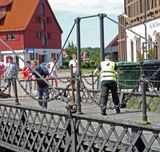 Men hand-cranking 1855 bridge in Klaipeda for boats to pass through
