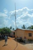 Electric wires supported by free-standing pole in Akato, Togo.JPG