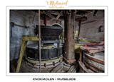 Vertical shaft with spurwheel, cogged pinions and the millstones with wooden casing