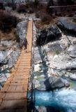 Brian crosses river bridge on descent