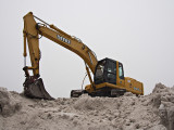 Excavator on snow pile #2