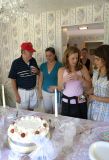 People inspecting the cake.