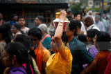 Devotee with milk pot on the head in the procession
