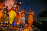 Family prays by the riverside at dawn