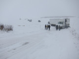 Tractor trailer holding up traffic on winter road