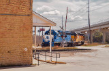 A quartet of diesel engines passes the McNeil, TX General Store 