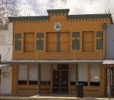 This colorful building is occupied by a bootmaker.