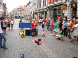 A street performer entertains the crowd with his dogs on Rue St.-Jean in the Upper Town section of Old Québec.