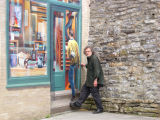 Richard follows the guy into the store in the Fresque des Qubecois mural on the side of a building  in Lower Town.